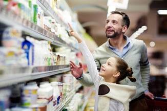 Man and young girl food shopping at grocery retail
