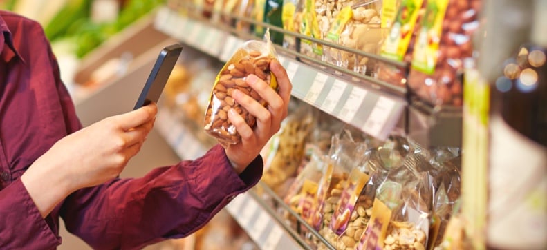 Close-up of someone removing a bottle from rows of glass bottles