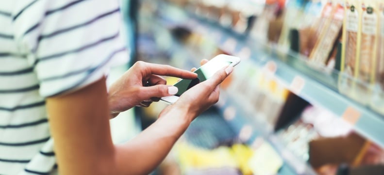 Shopper looking at phone in store