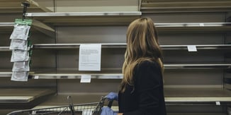 Grocery retail customer looking at empty shelves 