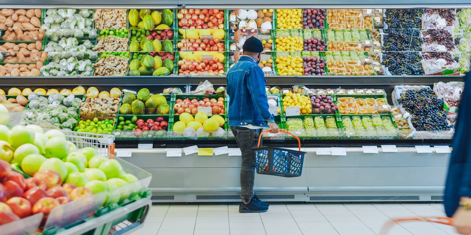 Customer browsing fruit at grocery retailer